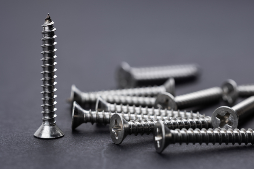 Tapping screws made of steel on Gray background, metal screw, iron screw, chrome screw,